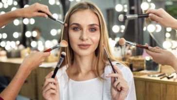 Wealthy woman having expensive makeup applied to her face