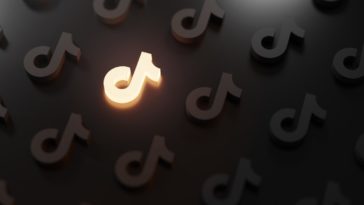 tiktok logo pattern with one glowing icon