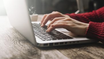 woman hands typing on a laptop