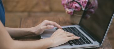 woman hands typing on a laptop