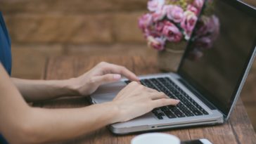 woman hands typing on a laptop