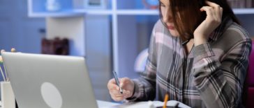 woman sitting at a desk wearing headphones