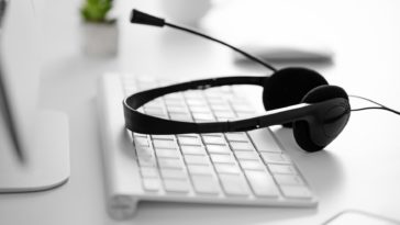 black headset on a white computer keyboard